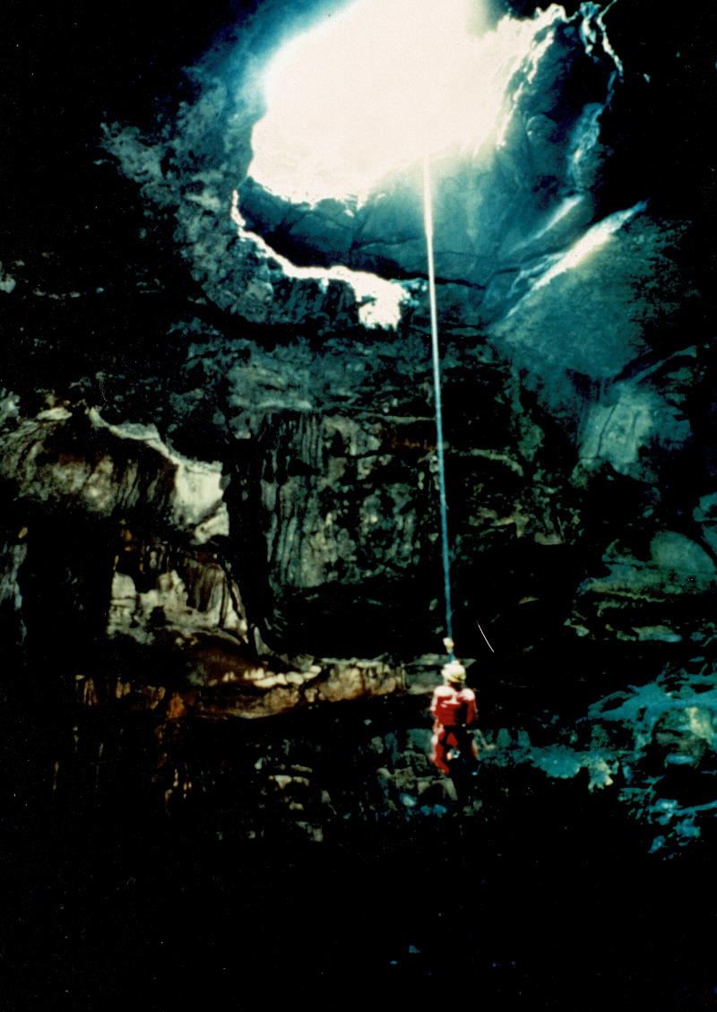 Caver climbing out of a pit